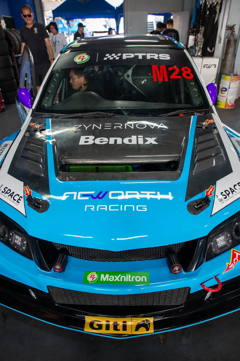 Chaiyavee Kongthed's #M28 Evo 8 with ETi carbon fiber hood in the pit garage
