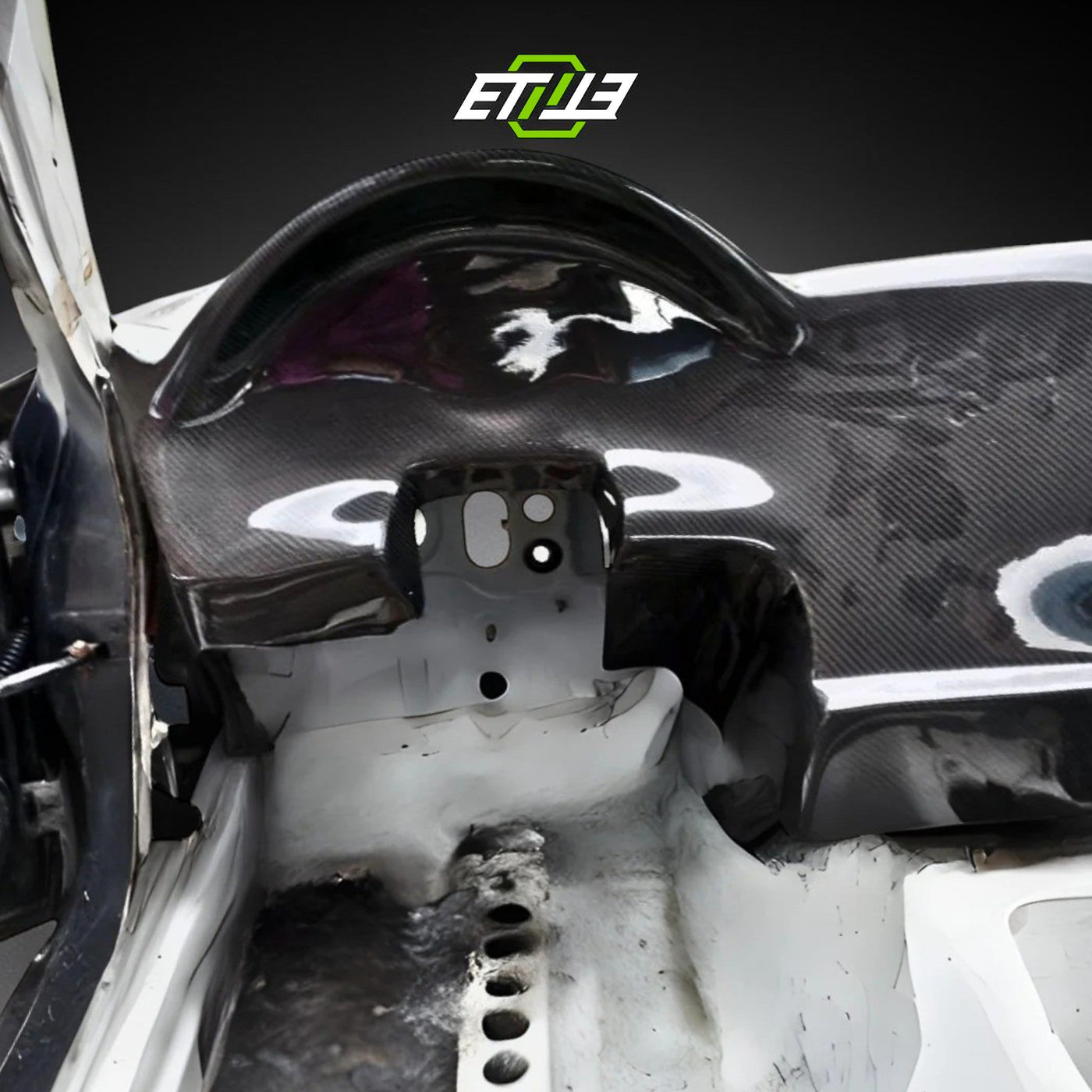 ETi carbon fiber race dash fitted in a stripped FD3S RX-7 shell