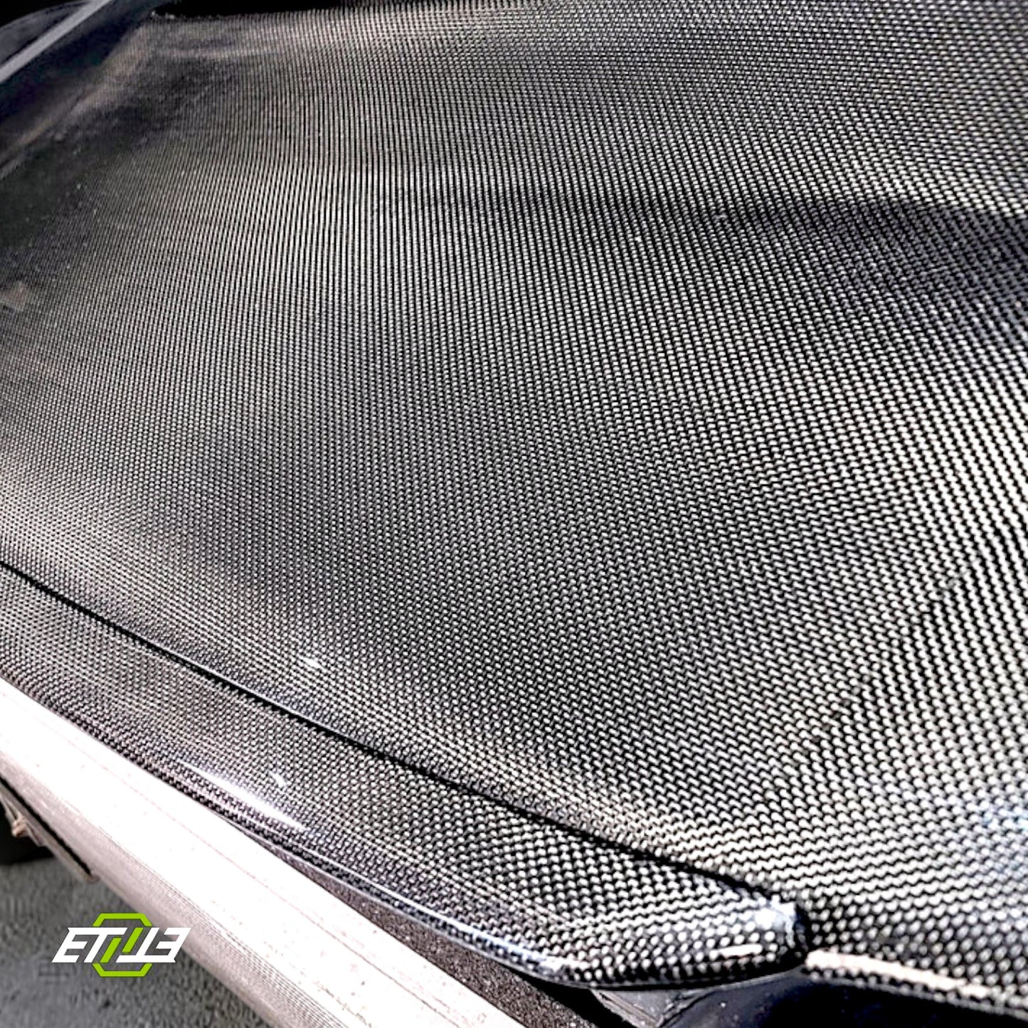 R32 NS hood lip — matte carbon, mounted on hood, ETi