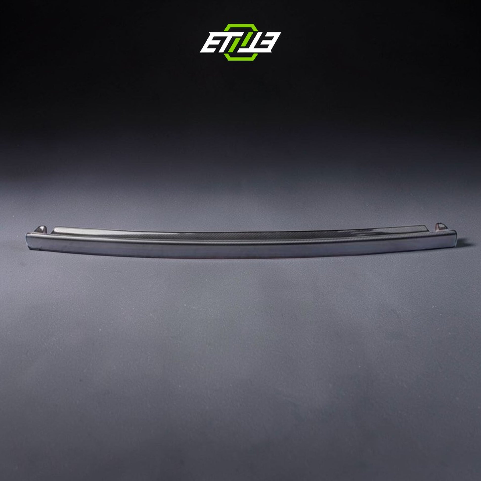 R32 NS trunk spoiler — gloss carbon fiber, front view, ETi