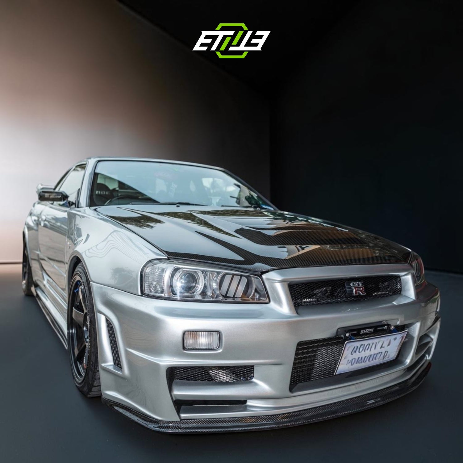 R34 Z-Tune style carbon vented hood — dry carbon, top view, ETi