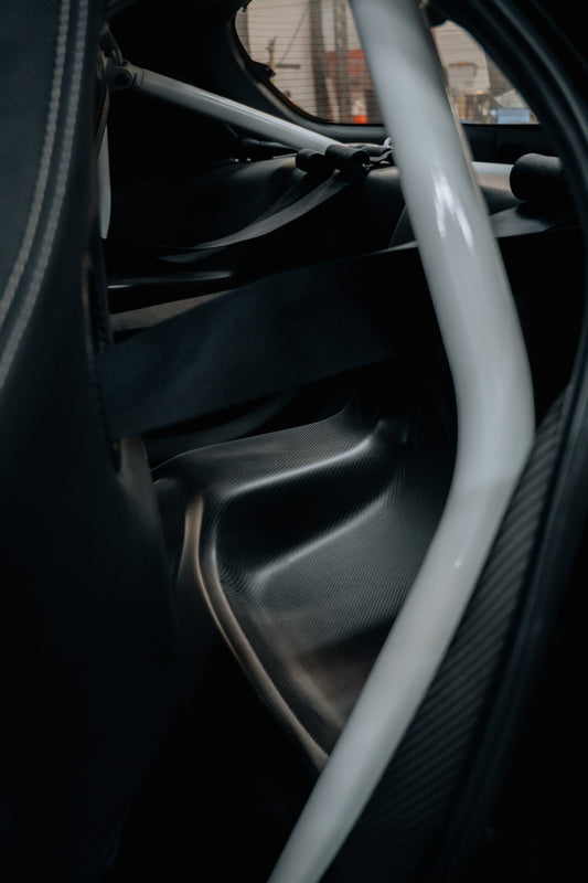 Mazda RX-7 FD3S dry carbon rear seat and bin delete installed with roll cage