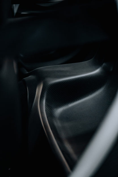 Close-up of Mazda RX-7 FD3S dry carbon rear seat delete panel installed