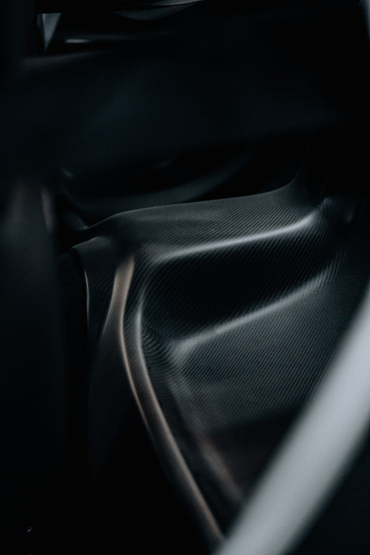 Close-up of Mazda RX-7 FD3S dry carbon rear seat delete panel installed
