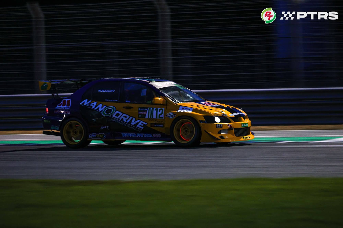 Tim Zielinski's M12 Mitsubishi Evo 8 at speed during a PTRS night race