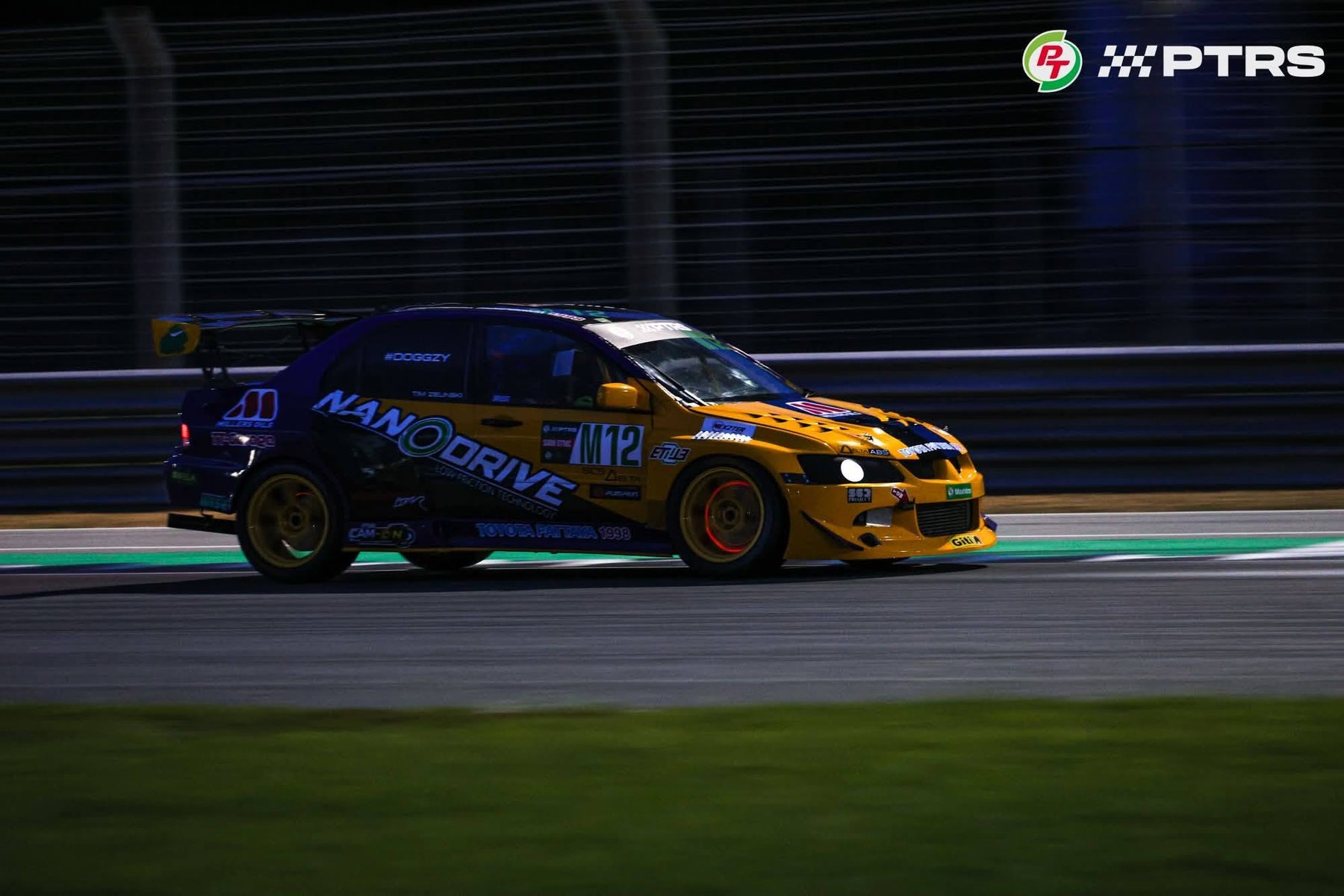 Tim Zielinski's M12 Mitsubishi Evo 8 at speed during a PTRS night race